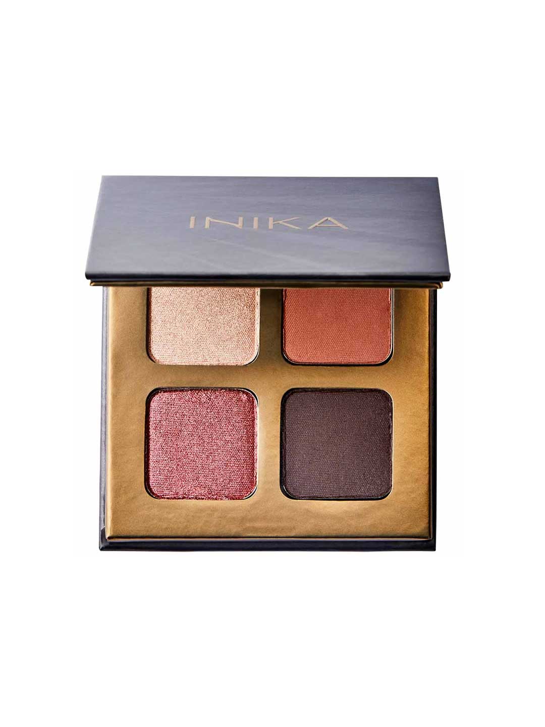 The INIKA Organic Eyeshadow Quad - Flowers 8g features four vegan, pressed mineral shades—shimmery beige, matte terracotta, shimmery rose, and matte dark brown—in a sleek gold and black compact.