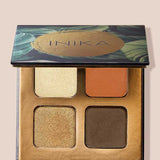 An open INIKA Organic Eyeshadow Quad - Sunset 8g shows four shades—shimmery gold, matte orange, shimmery bronze, and matte brown—in a decorative case with a green and gold lid design.