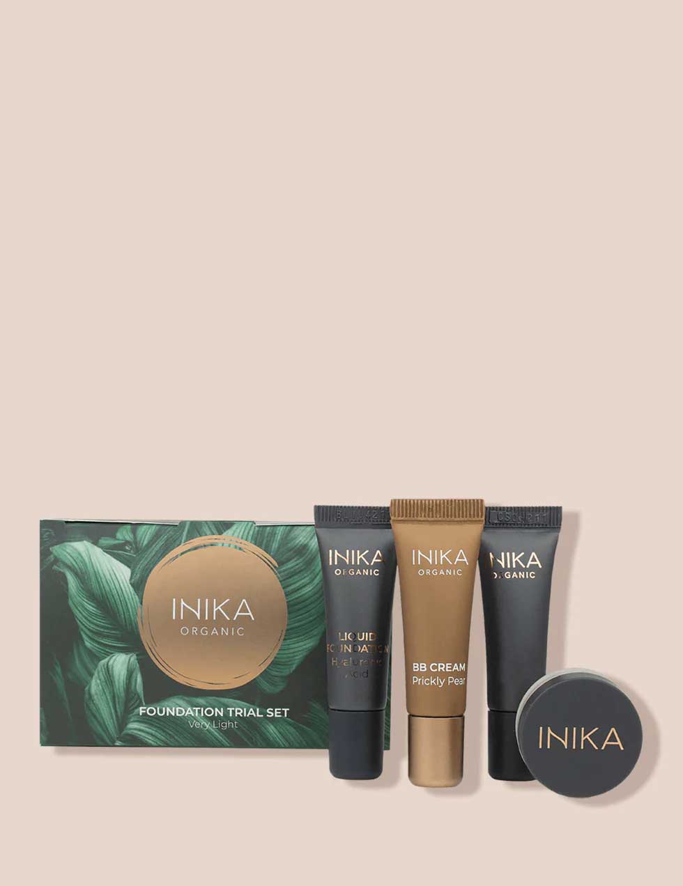 INIKA Organic Foundation Trial Sets - 4 Piece Set includes four sample tubes and a small round vegan foundation container in earth-toned packaging, displayed on a light beige background.