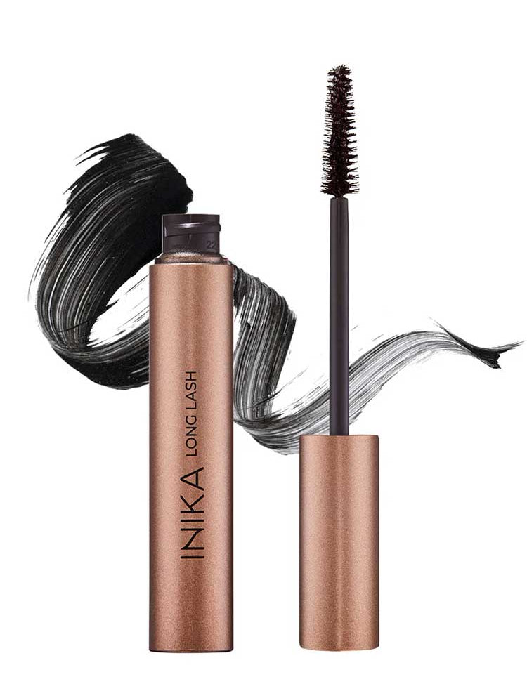 A metallic rose gold tube of INIKA Organic Long Lash Mascara 8ml with its wand removed displays the brush. Behind them, a bold black lengthening mascara swipe appears on a white background.