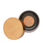 An open INIKA compact with a gold lid shows a mesh-covered cushion foundation—perfect to pair with INIKA Organic Loose Mineral Bronzer - Sunkissed 8g for a flawless finish.