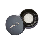 The INIKA Organic Mattify Mineral Setting Powder 7g comes in a sleek black round container, partially open to show its light mineral powder—ideal for completing your organic makeup routine.