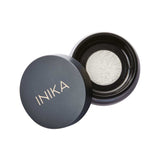 The INIKA Organic Mattify Mineral Setting Powder 7g comes in a sleek black round container, partially open to show its light mineral powder—ideal for completing your organic makeup routine.