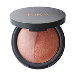 An open round compact reveals the INIKA Organic Mineral Baked Blush Duo - Pink Tickle 6.5g, featuring domed vegan blush in peach and rose shades from the Mineral Baked Blush collection.