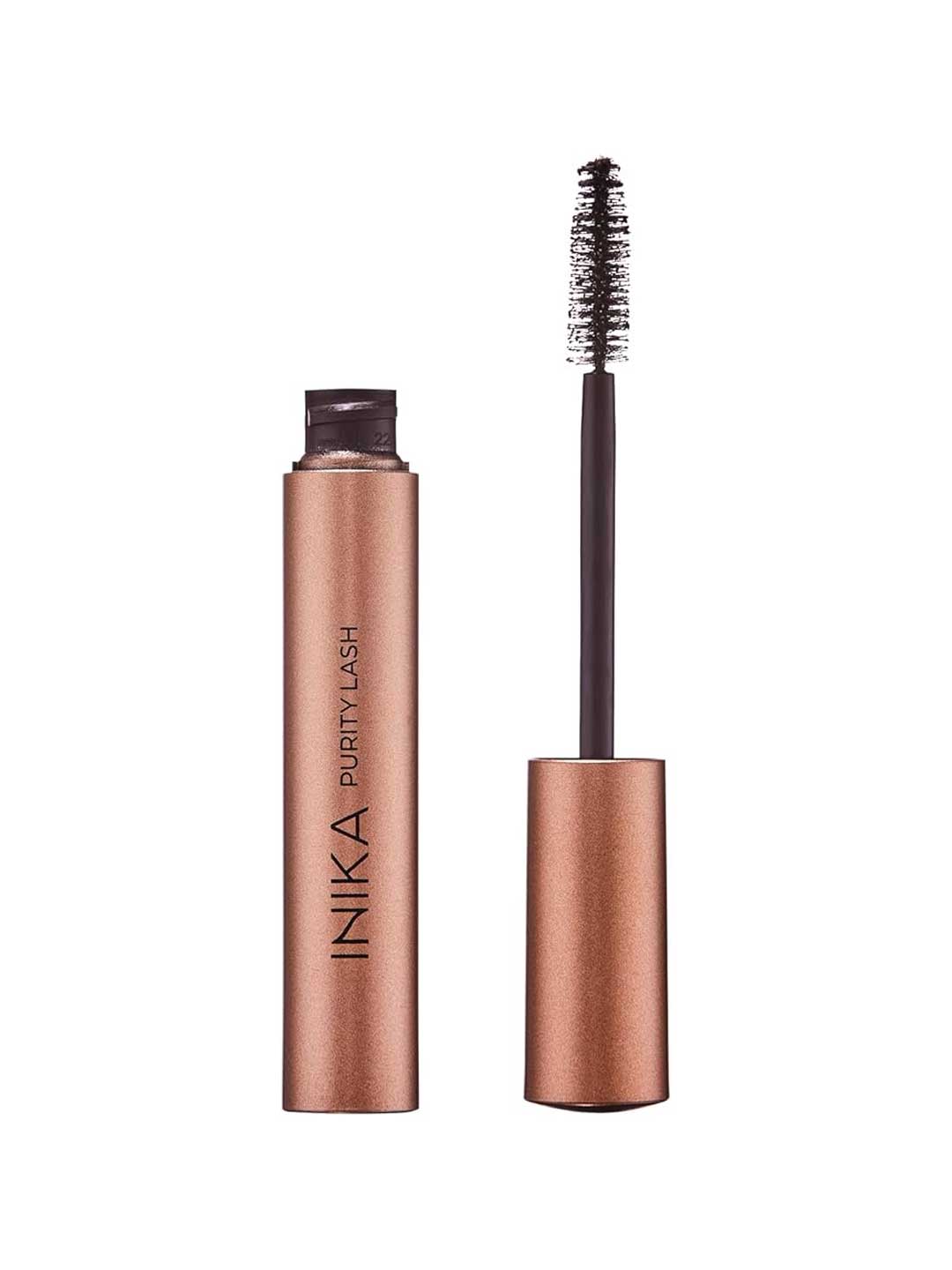 A metallic rose gold tube labeled INIKA Organic Purity Lash Mascara - Black 8.5ml is shown with its matching wand, featuring a bristled applicator coated in hypoallergenic organic mascara—ideal for sensitive eyes.