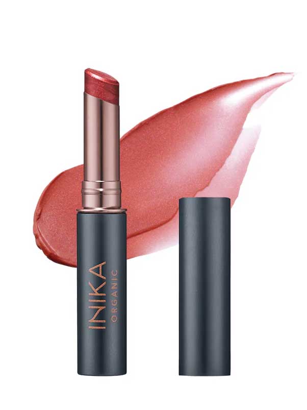 The INIKA Organic Tinted Lip Balm - Cosmic 3.5g is a rose-pink, moisturising vegan lip balm in a dark metallic tube with the cap off; "INIKA ORGANIC" appears on the label and a swipe of the color is shown in the background.