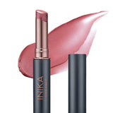 The INIKA Organic Tinted Lip Balm - Mulberry 3.5g features a rose-pink hue and comes in a sleek metallic black and gold case, ideal to use alone or paired with your favorite vegan lip balm for extra moisture.