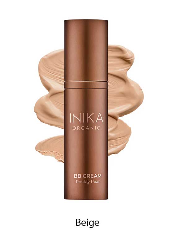 A bronze bottle of INIKA Organic Organic BB Cream 30ml in shade Beige stands before a beige cream smear labeled "Beige"—an organic BB cream that provides a natural satin finish.