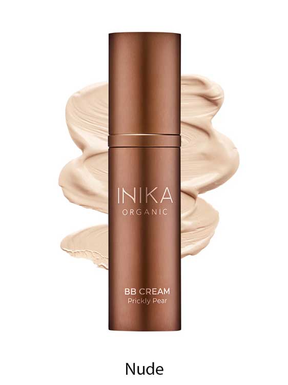 A bronze bottle of INIKA Organic BB Cream 30ml in Prickly Pear shade, a vegan beauty balm with a natural satin finish, stands before nude cream swatches, with "Nude" written below.