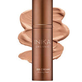 A bronze bottle of INIKA Organic Organic BB Cream 30ml in shade Tan, a vegan satin-finish beauty balm, is displayed with its creamy tan product swatched behind it.