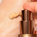 A close-up shows a hand dispensing INIKA Organic BB Cream 30ml from a bronze pump bottle onto the skin, offering a natural satin finish.