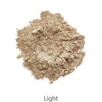 A mound of light beige powder from the INIKA Organic Foundation Trial Sets - 4 Piece Set is shown on a white background, with "Light" written below.