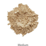 A pile of loose, medium beige INIKA Organic Foundation Trial Sets - 4 Piece Set is displayed on a white background with "Medium" below, ideal for those seeking a natural-finish foundation.