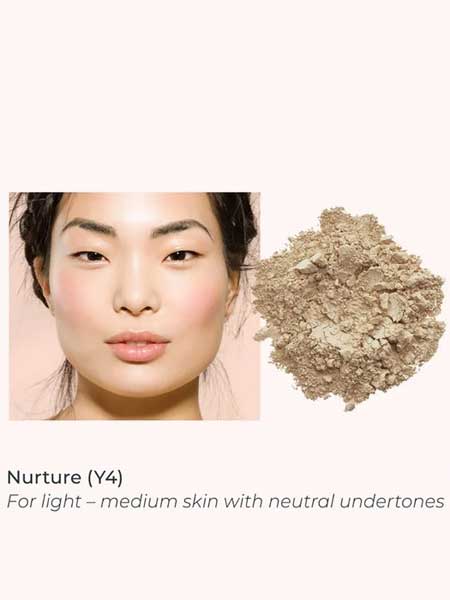 A woman with light–medium, neutral-toned skin wears a natural look next to INIKA Organic Loose Mineral Foundation SPF25 8g—ideal for light–medium skin seeking a non-comedogenic finish.