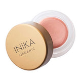 A small round container of INIKA Organic Lip & Cheek Cream Dusk 3.5g with a gold lid, partially open to show the soft pink vegan formula inside, perfect for a dewy finish on lips and cheeks.