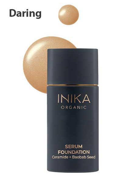 A bottle of INIKA Organic Serum Foundation 25ml labeled Daring is displayed, with hydrating foundation drops in the background.
