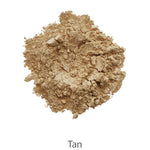 A heap of loose, tan-colored powder with a crumbly texture is shown on a white background, labeled "Tan." It appears to be from the INIKA Organic Foundation Trial Sets - 4 Piece Set.
