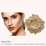 A woman with medium skin and golden undertones sits beside INIKA Organic Loose Mineral Foundation SPF25 8g. Text: Trust (Y6) for medium–dark skin with golden undertones.