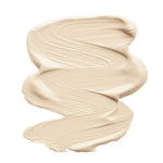 A smooth, thick swatch of INIKA Organic Liquid Foundation 30ml in light beige is spread in a zigzag on a white background. The word Cream appears below the swatch.