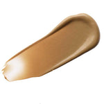 A swatch of Luk Beautifood Instant Glow Skin Tint 30ml in Nude 6: Tan, a light coverage tinted moisturiser for a radiant glow, is shown on a white background.