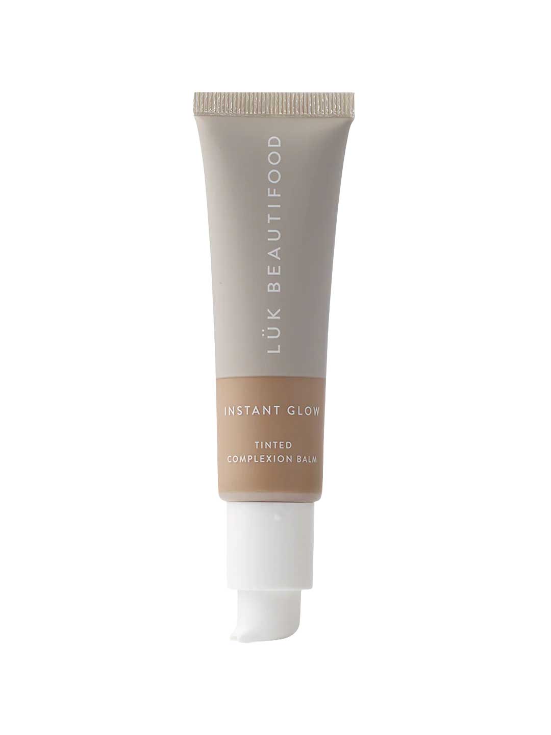 A 30ml tube of Luk Beautifood Instant Glow Skin Tint with a light beige label and white pump, standing upright on a white background, for a natural luminous finish.