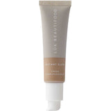 A 30ml tube of Luk Beautifood Instant Glow Skin Tint with a light beige label and white pump, standing upright on a white background, for a natural luminous finish.
