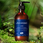 Antipodes Juliet Anti-Blemish Gel Cleanser bottle among native greenery