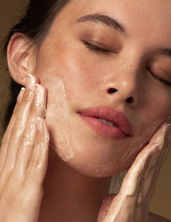 Model washing her face with Antipodes Juliet Anti-Blemish Gel Cleanser