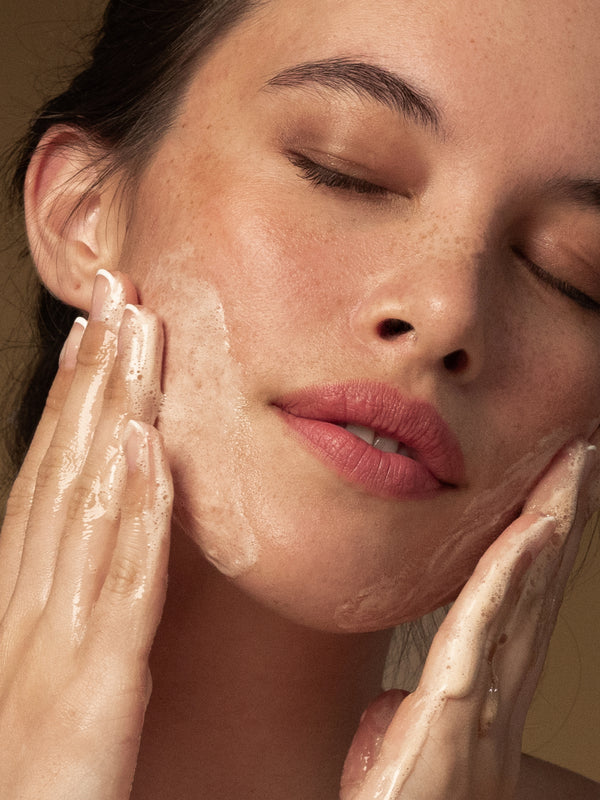 Model washing her face with Antipodes Juliet Anti-Blemish Gel Cleanser