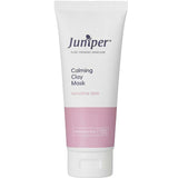 A white and pink tube labeled Juniper Calming Clay Mask 100g for sensitive skin, designed to reduce redness. Marked for practitioner use only.