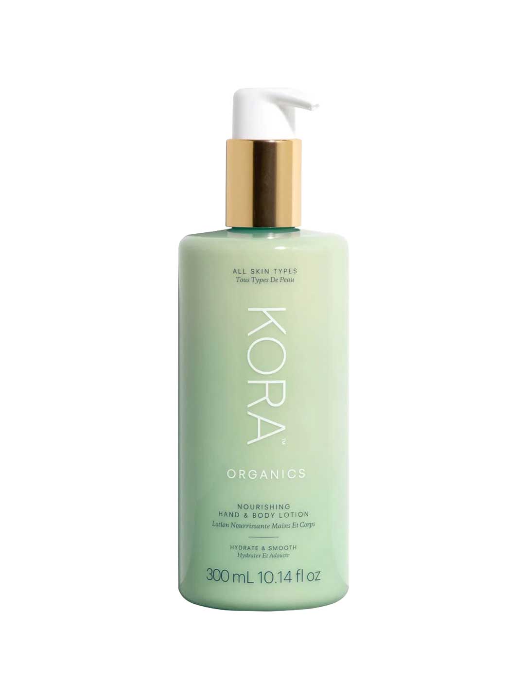 A green 300ml bottle of KORA Organics Nourishing Hand & Body Lotion with a gold and white pump, designed for all skin types and providing long-lasting hydration.