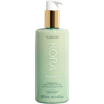 A green 300ml bottle of KORA Organics Nourishing Hand & Body Lotion with a gold and white pump, designed for all skin types and providing long-lasting hydration.