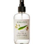 A clear spray bottle labeled Koala Eco Pillow and Linen Spray Rosalina, Peppermint & Eucalyptus 250ml, with eucalyptus and peppermint illustrations, a black nozzle, and an eco-friendly formula for freshening linens.
