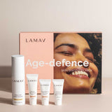 The LAMAV Age-Defence Skin Discovery Pack (4 Pack) is displayed in front of its box, featuring a smiling face—ideal for those seeking organic, anti-ageing skincare from LAMAV.