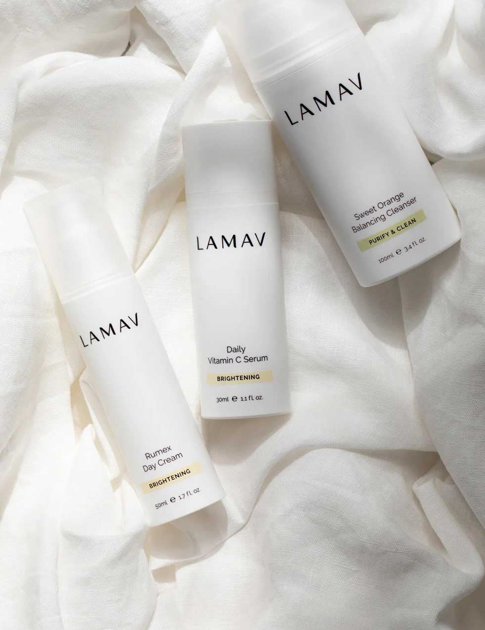 The LAMAV Brightening Skin Discovery Pack (3 Pack) is displayed on soft fabric, highlighting LAMAV’s organic brightening skincare for radiant skin and effective pigmentation treatment.