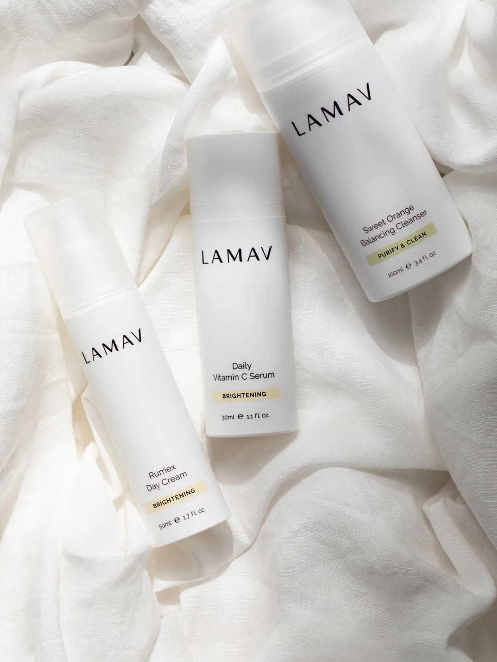 The LAMAV Brightening Skin Discovery Pack (3 Pack) is displayed on soft fabric, highlighting LAMAV’s organic brightening skincare for radiant skin and effective pigmentation treatment.