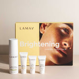 The LAMAV Brightening Skin Discovery Pack (4 Pack) is displayed with four white tubes and bottles for brightening, arranged before a yellow box showing a woman's face. Brand: LAMAV.
