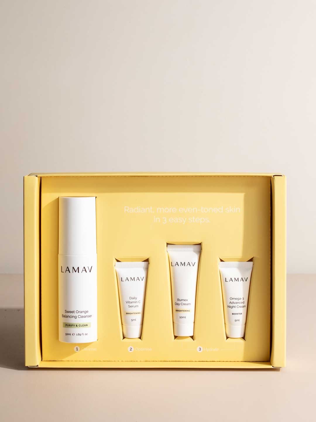 The LAMAV Brightening Skin Discovery Pack (4 Pack) includes Sweet Orange Balancing Cleanser, Daily Vitamin C Serum, Omega-3 Advanced Night Cream, and Bio-Active Day Cream for radiant skin.