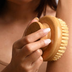 Hand holding the LAMAV Garshana Dry Body Brush