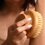 Hand holding the LAMAV Garshana Dry Body Brush