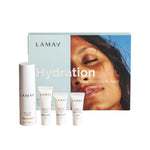 The LAMAV Hydration Skin Discovery Pack (4 Pack) features four hydration skincare products in sleek white tubes and bottles, displayed before a blue box with a woman's face—ideal for starting your organic skincare journey.