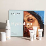 LAMAV Hydration Skin Discovery Pack (4 Pack) by LAMAV shown with a pump bottle, three small tubes, and a box featuring a sun-kissed face. This organic skincare set highlights hydrating care with hyaluronic acid on a neutral background.