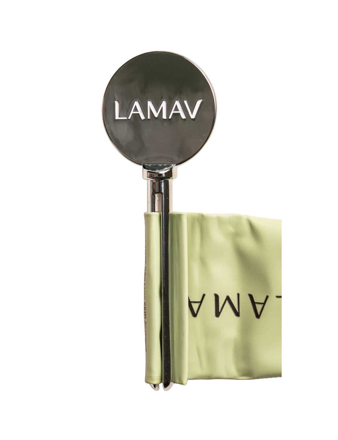 The LAMAV Tube Key—a shiny, round metal tool engraved with LAMAV—hangs from a pale green, folded fabric band featuring the logo, presented as a zero-waste beauty solution on a crisp white background.