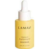 A yellow bottle of LAMAV Vitamin C Brightening Oil 30ml with a white dropper cap, labeled as an organic face oil for brightening and glow.