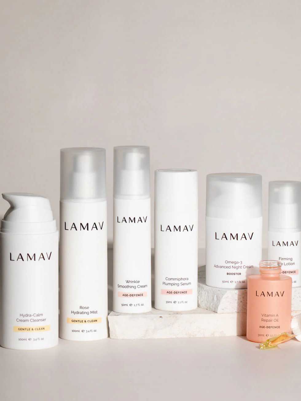 Seven LAMAV Age-Defence Complete Skincare Collection products for dry/sensitive skin—featuring creams, serum, mist, lotion, and oil—are arranged on a light background. Perfect for age defence and gentle care.