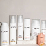 Seven LAMAV Age-Defence Complete Skincare Collection products for dry/sensitive skin—featuring creams, serum, mist, lotion, and oil—are arranged on a light background. Perfect for age defence and gentle care.