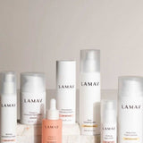 The LAMAV Age-Defence Complete Skincare Collection for Dry/Sensitive Skin (7 pack) features creams, serums, and lotions in white bottles and jars—ideal for sensitive skin; beautifully arranged on a light backdrop.