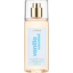 A clear bottle of Lavanila Healthy Hair and Body Mist Vanilla Coconut with a gold spray nozzle and blue label, containing 150ml of vegan fragrance for hair and body.