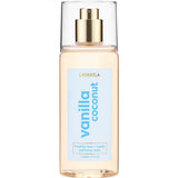 A clear bottle of Lavanila Healthy Hair and Body Mist Vanilla Coconut with a gold spray nozzle and blue label, containing 150ml of vegan fragrance for hair and body.