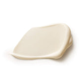 Close-up of a smooth ivory Dr Hauschka Lavender Sandalwood Body Cream smear with a raised folded edge and a soft sheen on white.